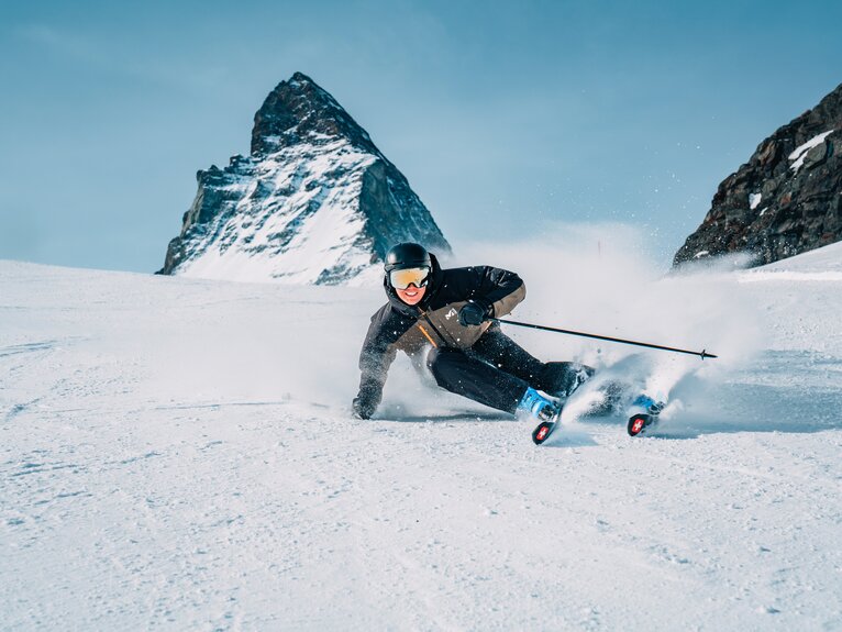 Glücklicher Skifahrer fährt auf Piste mit dem ikonischen Matterhorn im Hintergrund | © Zermatt Bergbahnen 