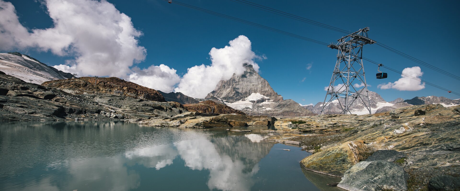 Theodulsee auf Trockener Steg | © Mitch Pitmann Der Theodulsee auf Trockener Steg, das Matterhorn und die Gondeln der Glacier Ride | © Mitch Pitmann